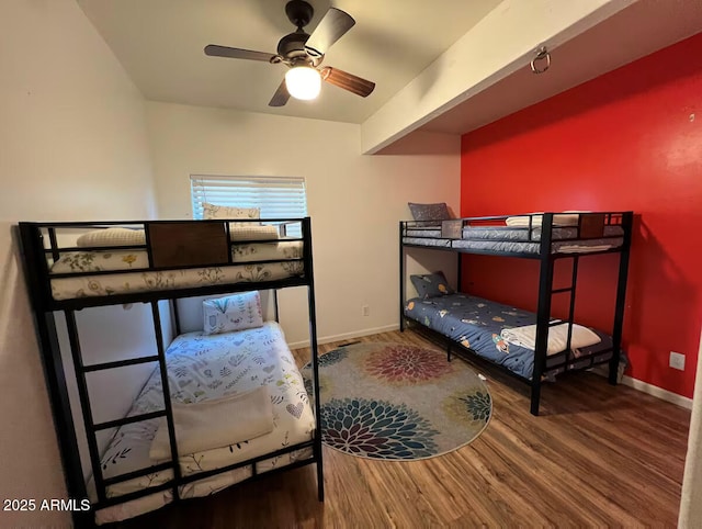 bedroom featuring baseboards and wood finished floors