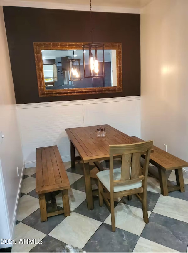 dining room with a chandelier and tile patterned floors