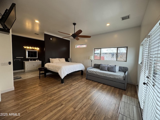 bedroom featuring recessed lighting, visible vents, baseboards, and wood finished floors