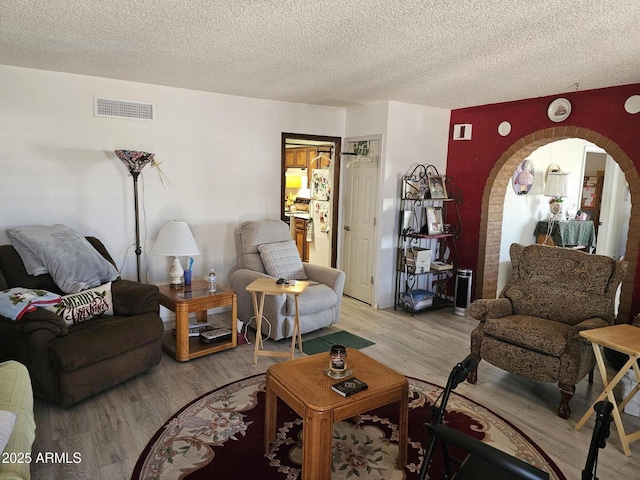 living room featuring hardwood / wood-style flooring and a textured ceiling