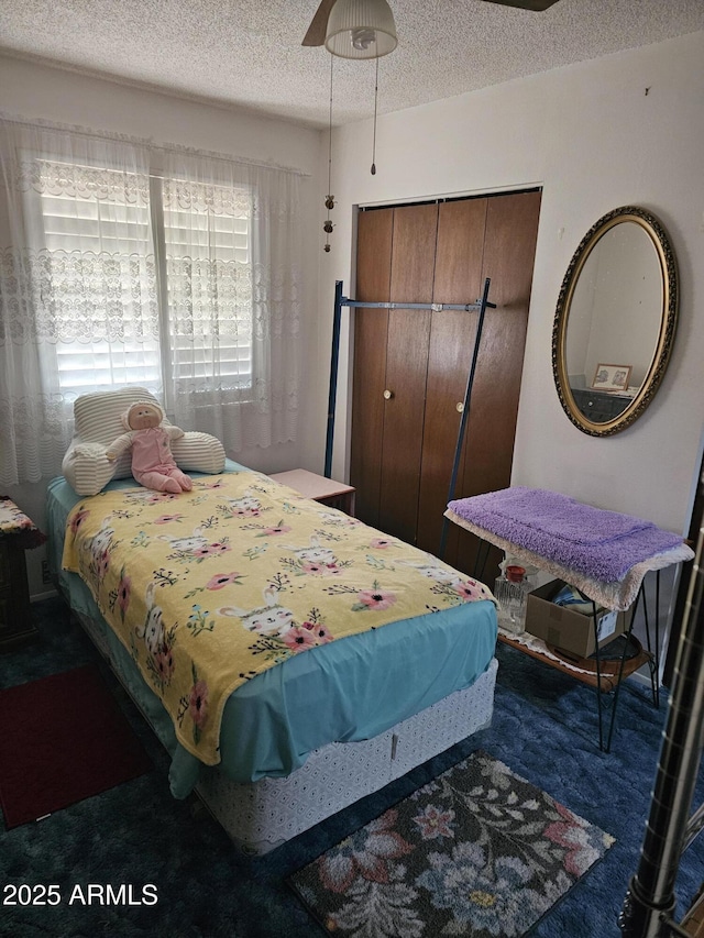 bedroom with a textured ceiling and a closet