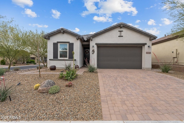 4244 Sawbuck Way, Wickenburg, AZ 85390 - ranch-style house with stucco siding, an attached garage, a tile roof, and decorative driveway