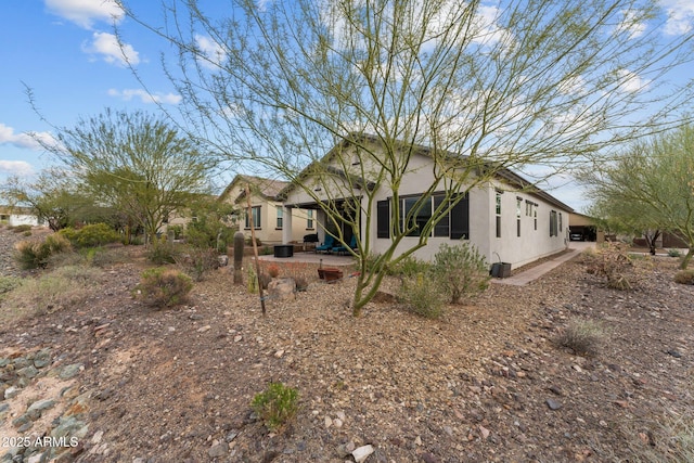 4244 Sawbuck Way, Wickenburg, AZ 85390 - rear view of house featuring stucco siding and a patio area