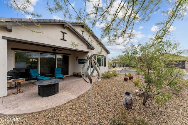 4244 Sawbuck Way, Wickenburg, AZ 85390 - rear view of house featuring stucco siding, an outdoor fire pit, ceiling fan, and a patio area