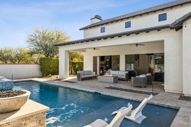 rear view of property featuring ceiling fan, a patio, an outdoor hangout area, fence, and stucco siding