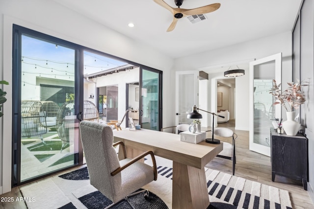 home office featuring recessed lighting, light wood-type flooring, visible vents, and a ceiling fan