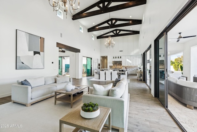 living area featuring light wood-type flooring, visible vents, and beam ceiling