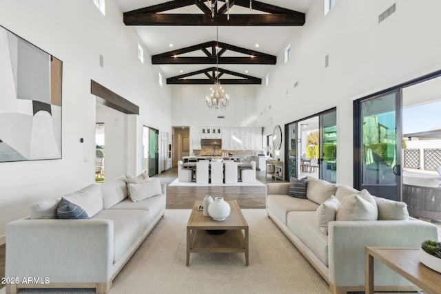 living area with a chandelier, visible vents, beamed ceiling, and high vaulted ceiling