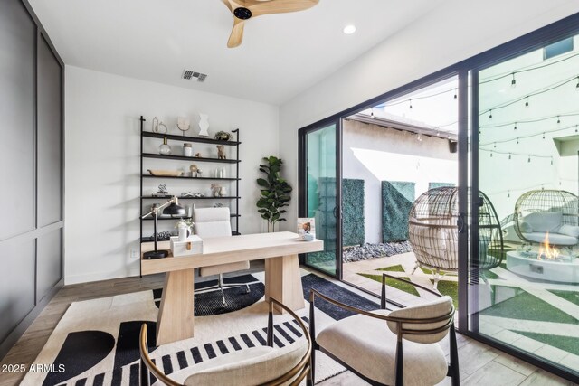 office featuring a ceiling fan, recessed lighting, visible vents, and wood finished floors