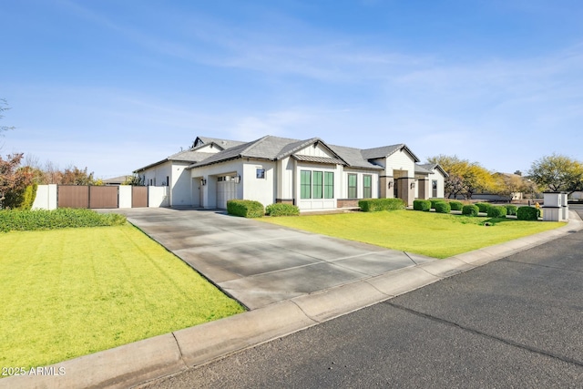 modern inspired farmhouse featuring stucco siding, a gate, fence, driveway, and a front lawn