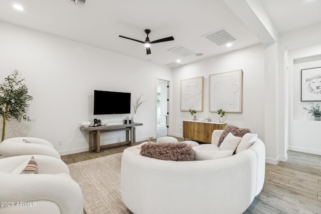 living area featuring baseboards, visible vents, ceiling fan, wood finished floors, and recessed lighting