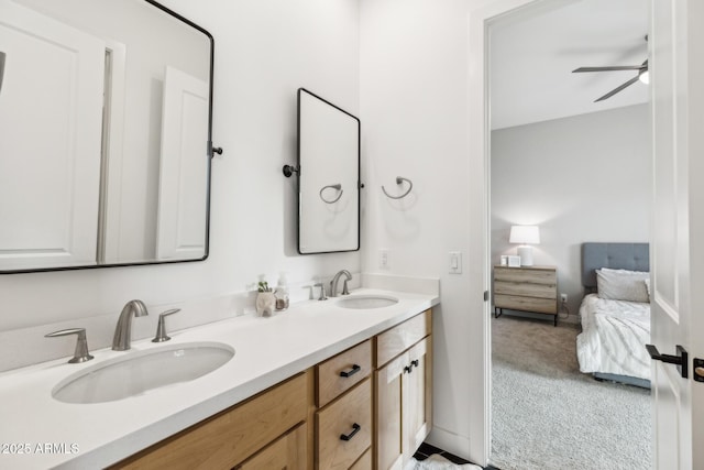 bathroom with ceiling fan, double vanity, a sink, and connected bathroom