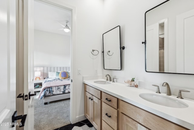 bathroom featuring ceiling fan, double vanity, ensuite bath, and a sink