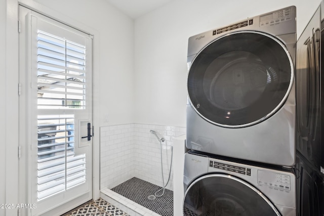 washroom with laundry area and stacked washer / drying machine