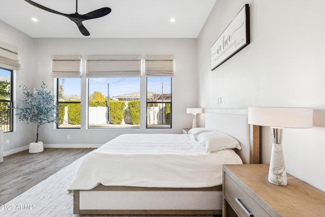 bedroom with recessed lighting, ceiling fan, baseboards, and wood finished floors