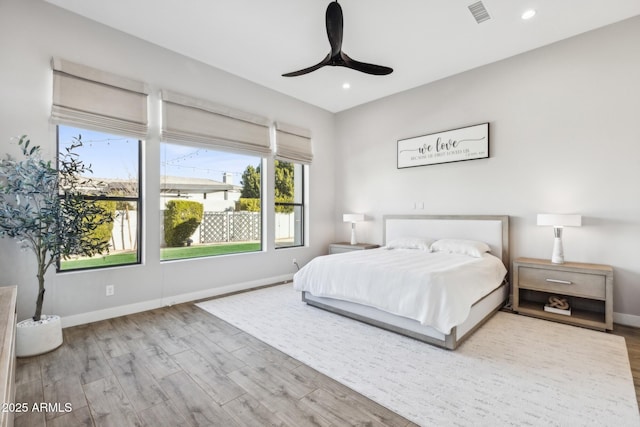 bedroom with recessed lighting, visible vents, baseboards, and wood finished floors