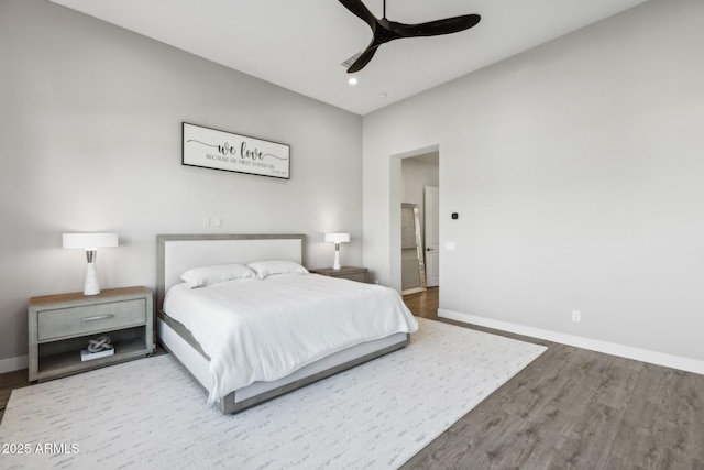 bedroom with ceiling fan, baseboards, and wood finished floors