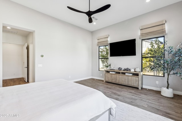 bedroom with visible vents, baseboards, wood finished floors, and recessed lighting