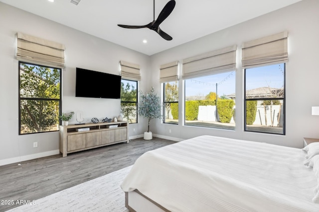 bedroom featuring a ceiling fan, recessed lighting, baseboards, and light wood finished floors