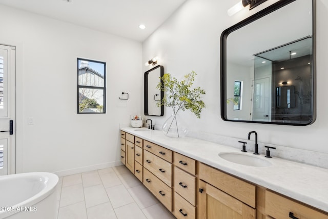 bathroom featuring double vanity, a soaking tub, a sink, and a shower stall