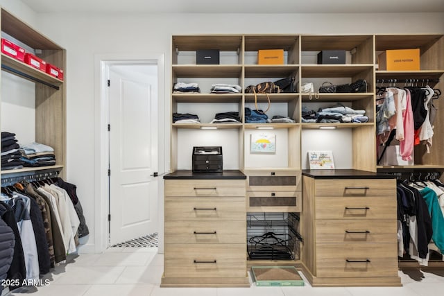 spacious closet featuring light tile patterned flooring