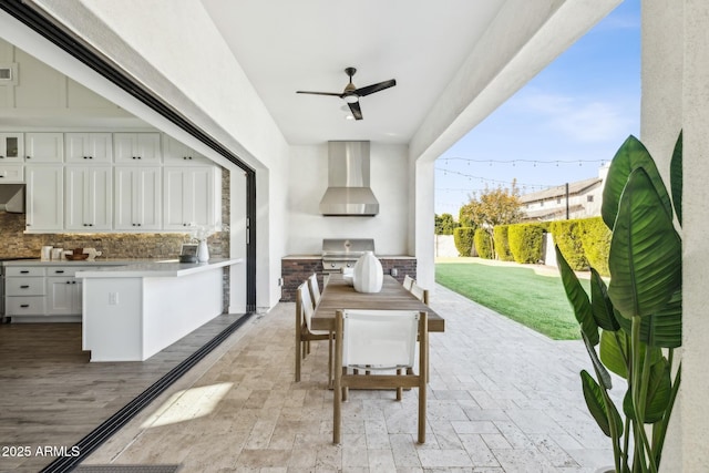 view of patio / terrace featuring outdoor dining area, visible vents, a ceiling fan, a grill, and exterior kitchen