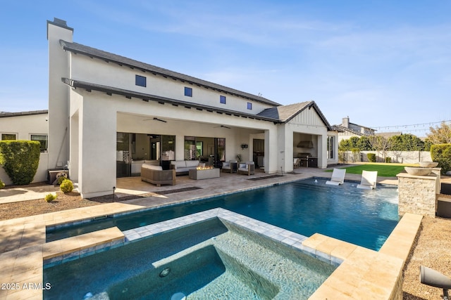 back of property featuring a ceiling fan, a patio area, a pool with connected hot tub, outdoor lounge area, and stucco siding