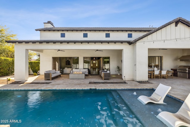 rear view of property featuring area for grilling, a ceiling fan, an outdoor living space, an outdoor pool, and a patio area