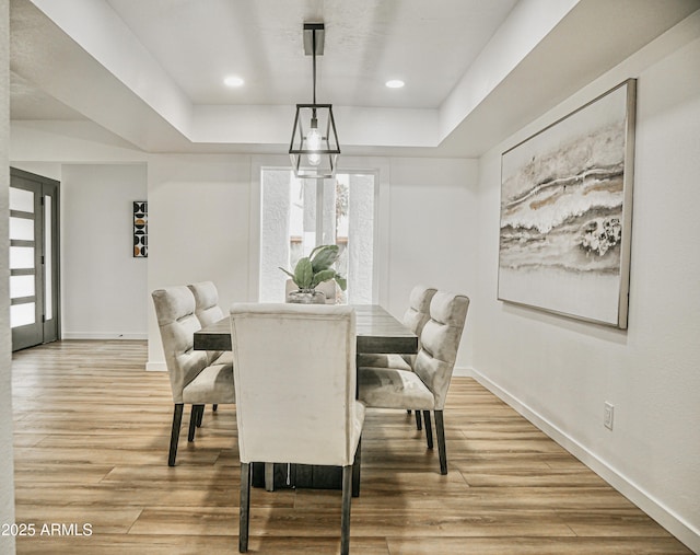 6401 E Eugie Ter, Scottsdale, AZ 85254 - dining space with a tray ceiling, baseboards, light wood-style flooring, and recessed lighting