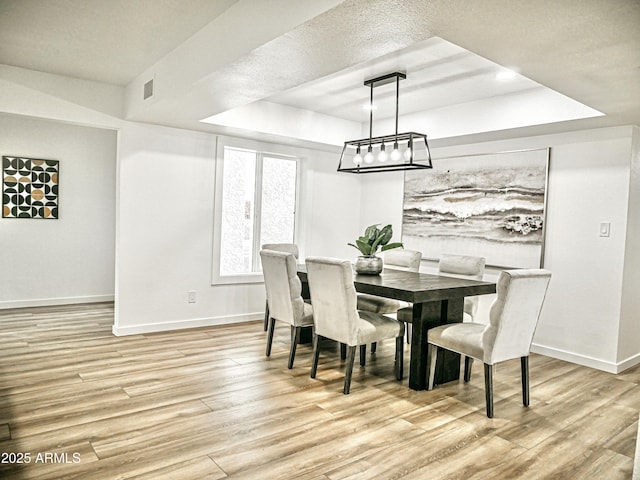 6401 E Eugie Ter, Scottsdale, AZ 85254 - dining room with a tray ceiling, baseboards, and light wood finished floors
