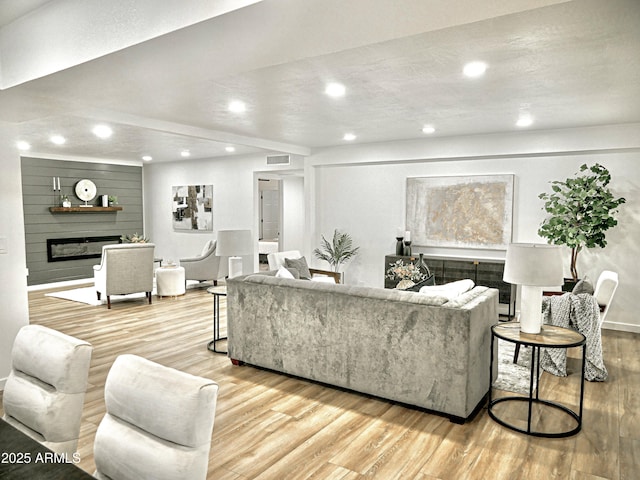6401 E Eugie Ter, Scottsdale, AZ 85254 - living area with a glass covered fireplace, recessed lighting, light wood-style floors, and baseboards