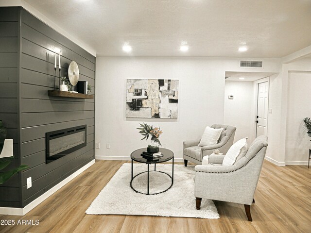 6401 E Eugie Ter, Scottsdale, AZ 85254 - living room featuring a glass covered fireplace, light wood-style floors, baseboards, and recessed lighting