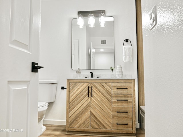 6401 E Eugie Ter, Scottsdale, AZ 85254 - bathroom featuring toilet, vanity, wood finished floors, and baseboards