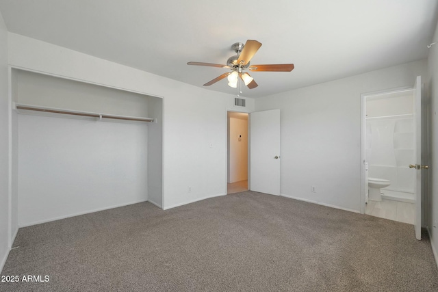 unfurnished bedroom with visible vents, ensuite bathroom, carpet flooring, and a closet