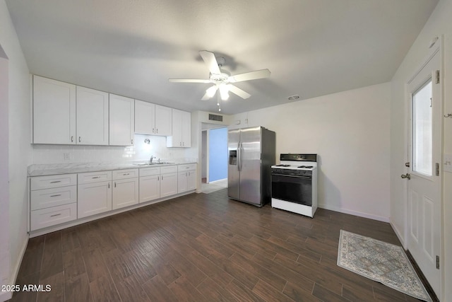 kitchen with white cabinets, stainless steel fridge with ice dispenser, white gas range, visible vents, and ceiling fan