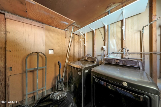 clothes washing area featuring separate washer and dryer and laundry area