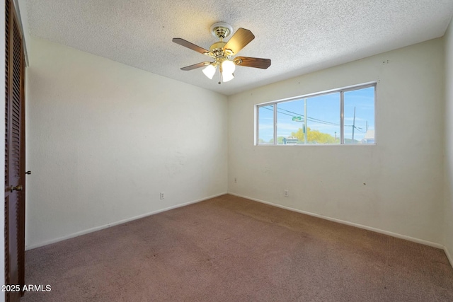 spare room with baseboards, carpet, a textured ceiling, and ceiling fan