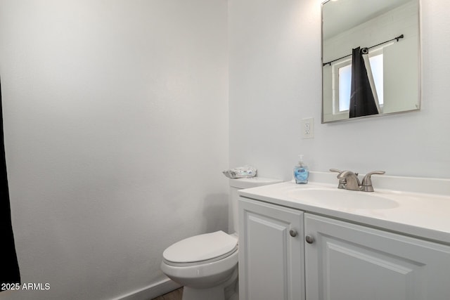 bathroom featuring toilet and vanity