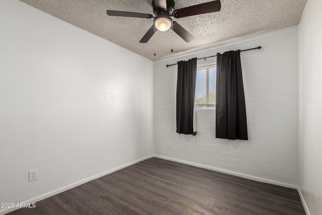 empty room featuring baseboards, a ceiling fan, a textured ceiling, and dark wood-type flooring