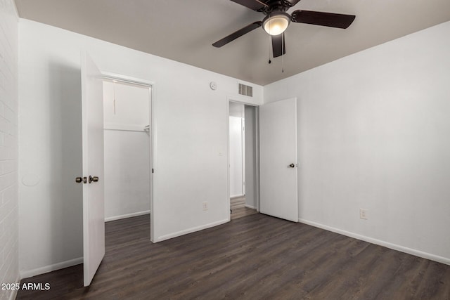unfurnished bedroom featuring visible vents, baseboards, and wood finished floors