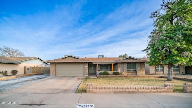 ranch-style home featuring a garage and a front yard