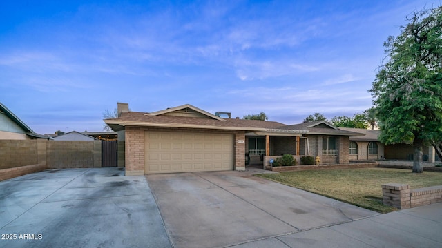 single story home featuring a garage and a front lawn