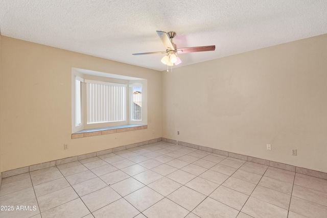 empty room featuring a textured ceiling and a ceiling fan