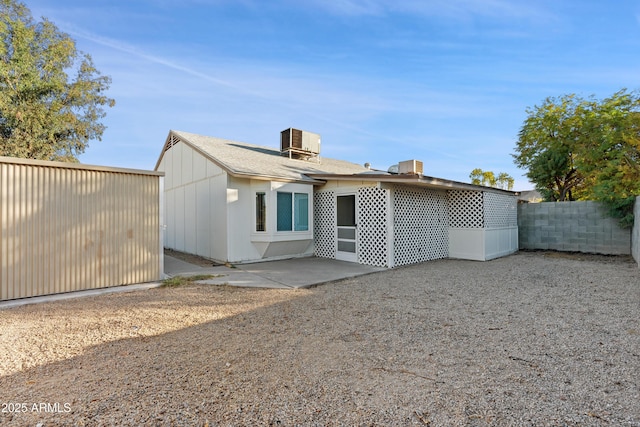 rear view of property with a patio, cooling unit, and fence