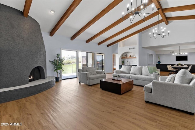 living room with high vaulted ceiling, an inviting chandelier, a fireplace, beam ceiling, and wood-type flooring