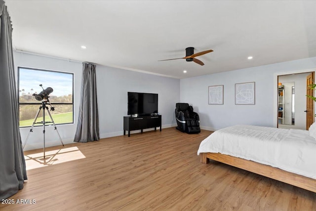 bedroom with light hardwood / wood-style flooring and ceiling fan