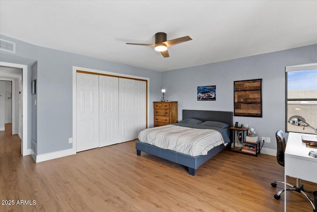 bedroom with ceiling fan, a closet, and light hardwood / wood-style floors