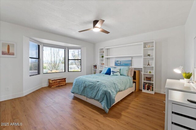 bedroom featuring hardwood / wood-style floors and ceiling fan