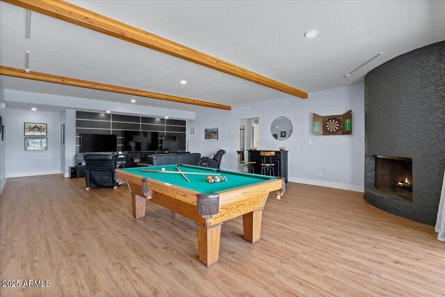 game room with a fireplace, beam ceiling, light hardwood / wood-style floors, and pool table