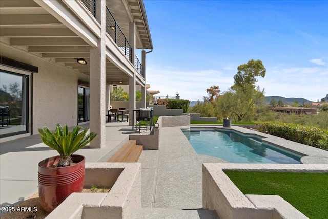 view of pool featuring a mountain view and a patio